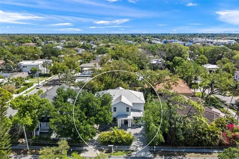 an aerial view of residential houses with city view