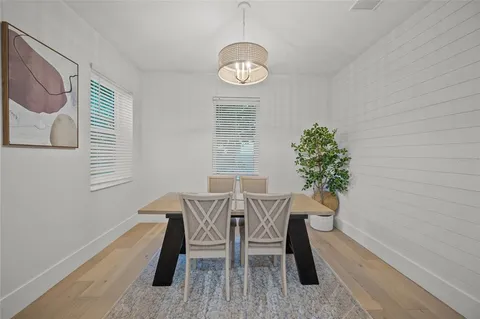 a large kitchen with a table and chairs