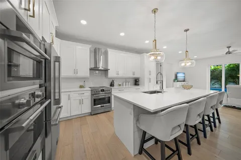 a kitchen with stainless steel appliances kitchen island granite countertop a sink and microwave