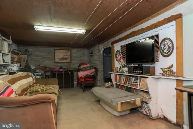 a living room with a couch and a bookshelf
