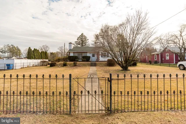 a view of a house with a yard covered in snow