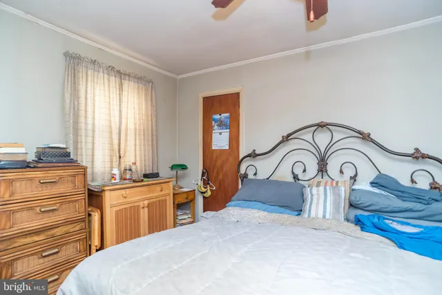 a bedroom with a bed and a dresser