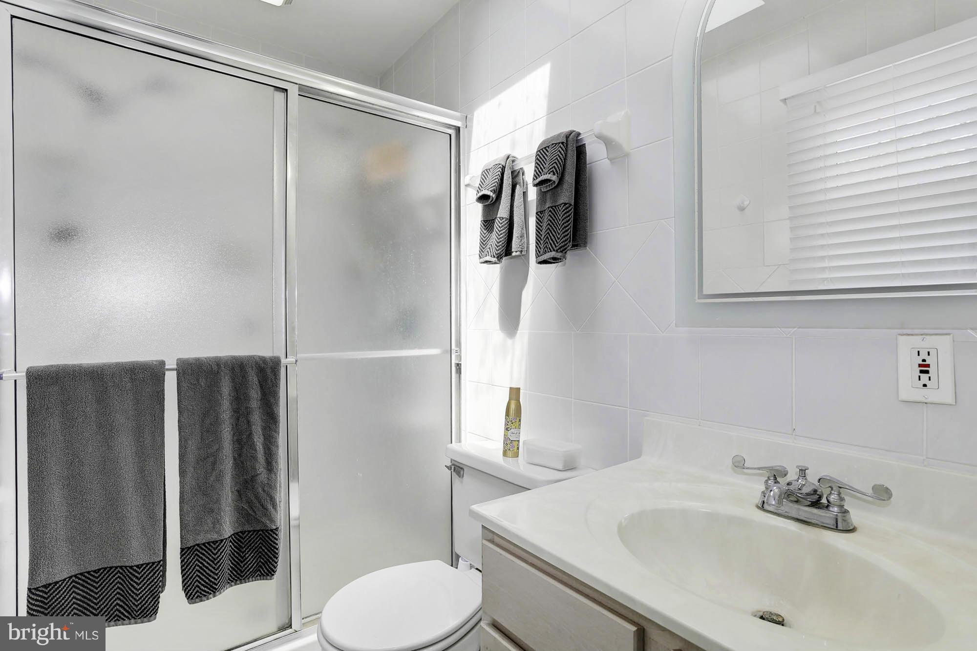 6501 Darwin Road Laurel, MD 20707 - Photo 13 of 30 a bathroom with a sink toilet and shower