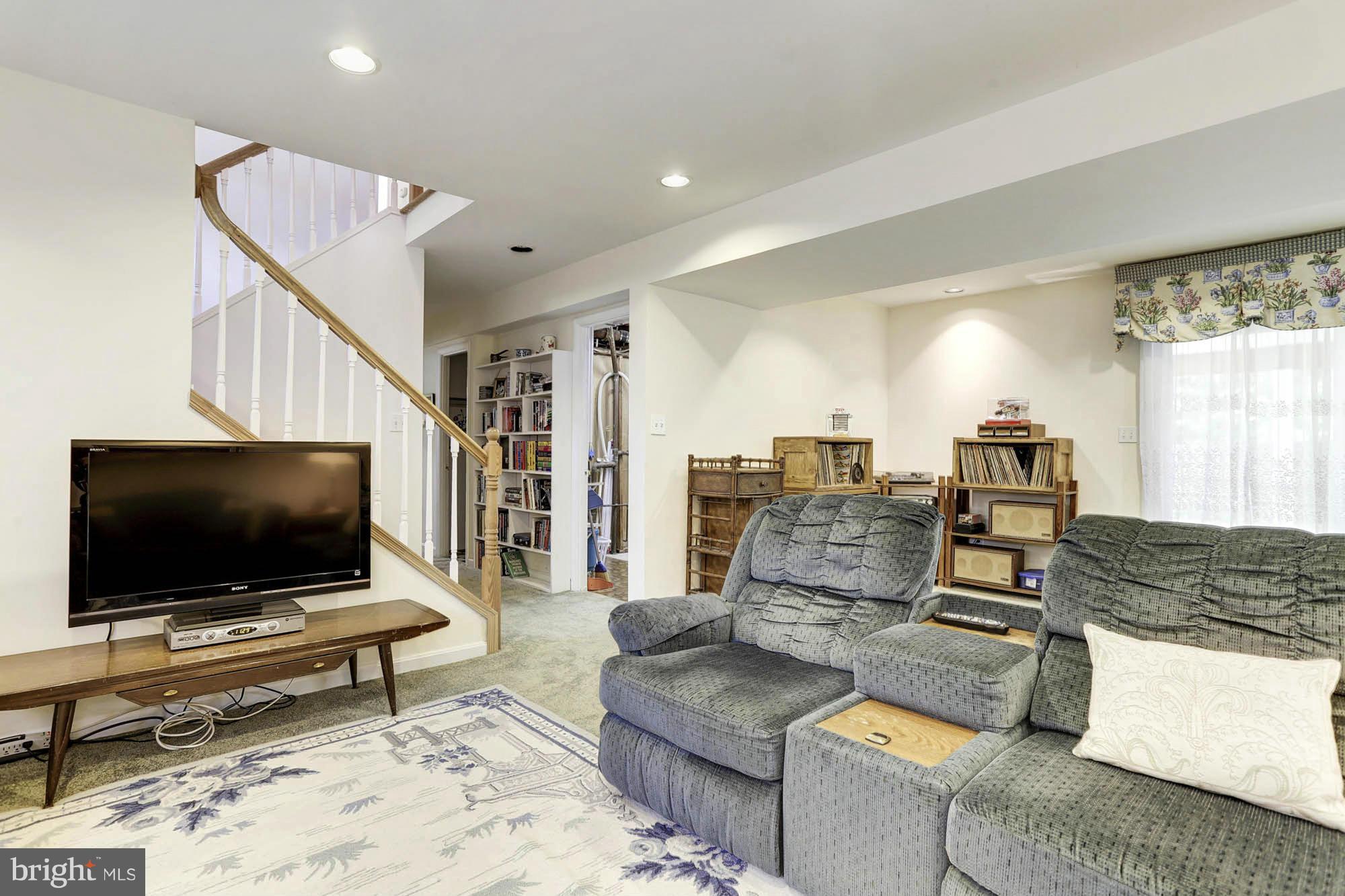 6501 Darwin Road Laurel, MD 20707 - Photo 21 of 30 a living room with furniture and a flat screen tv