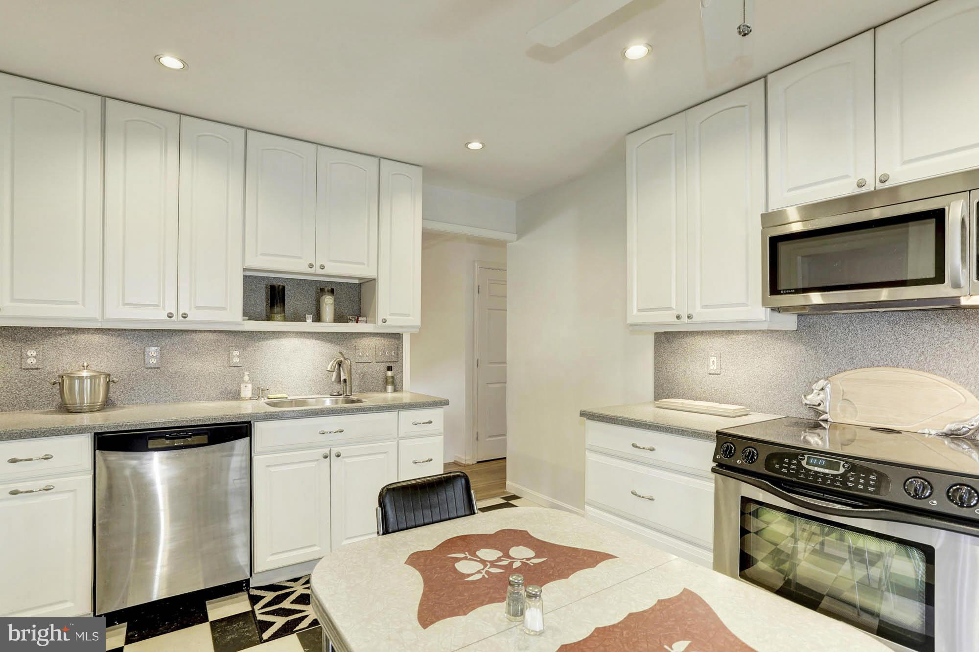 6501 Darwin Road Laurel, MD 20707 - Photo 9 of 30 a kitchen with stainless steel appliances a stove a sink and cabinets