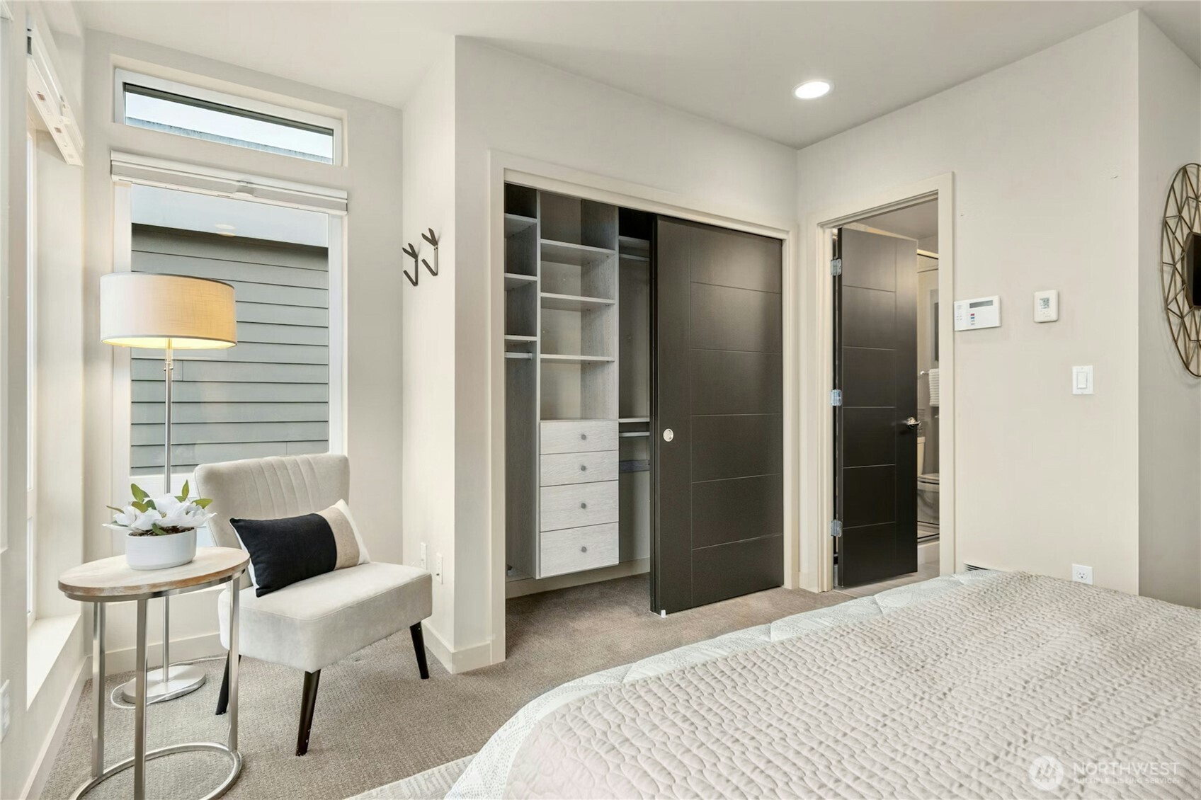 1743 Northwest 60th Street, Unit A Seattle, WA 98107 - Photo 14 of 33 a bedroom with a bed and a chair