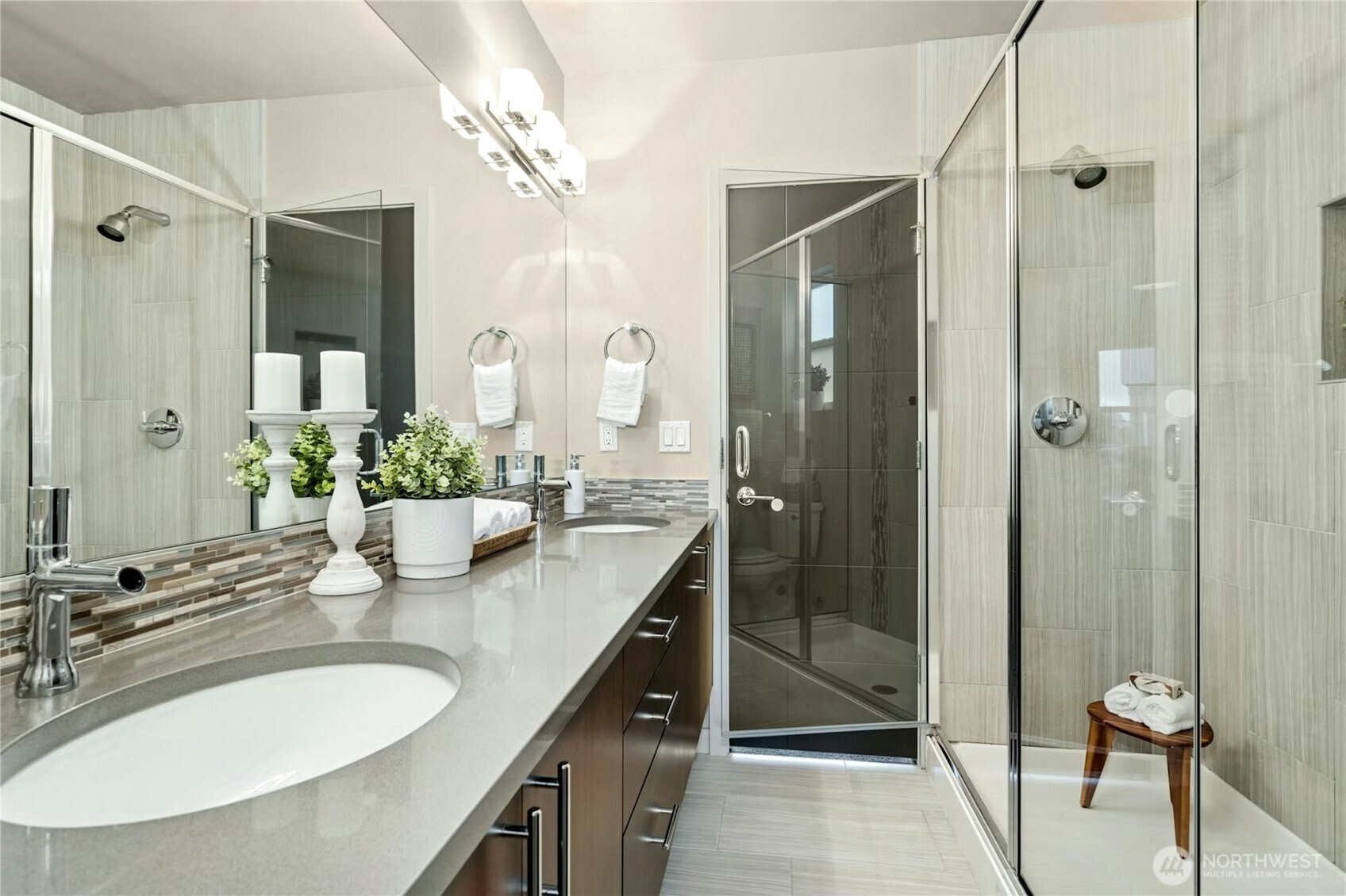 1743 Northwest 60th Street, Unit A Seattle, WA 98107 - Photo 15 of 33 a bathroom with a granite countertop sink a mirror and a shower