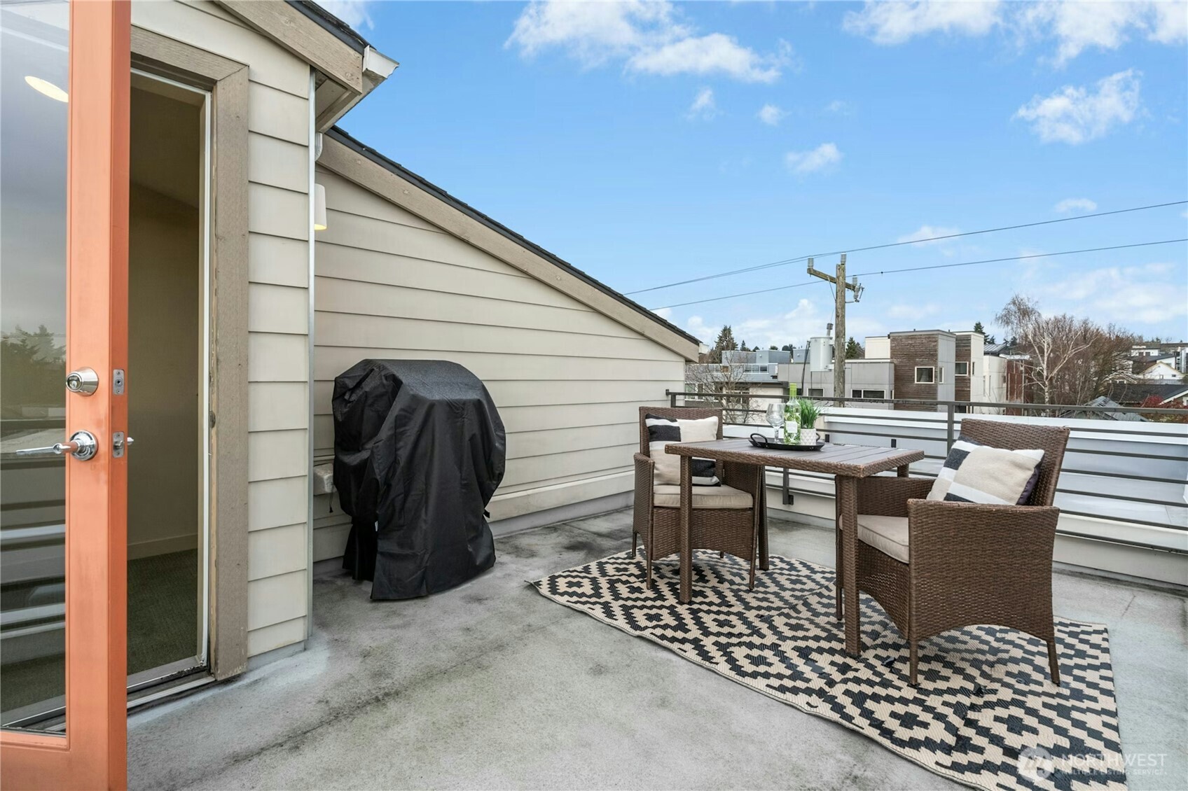 1743 Northwest 60th Street, Unit A Seattle, WA 98107 - Photo 22 of 33 a view of a patio with dining table and chairs