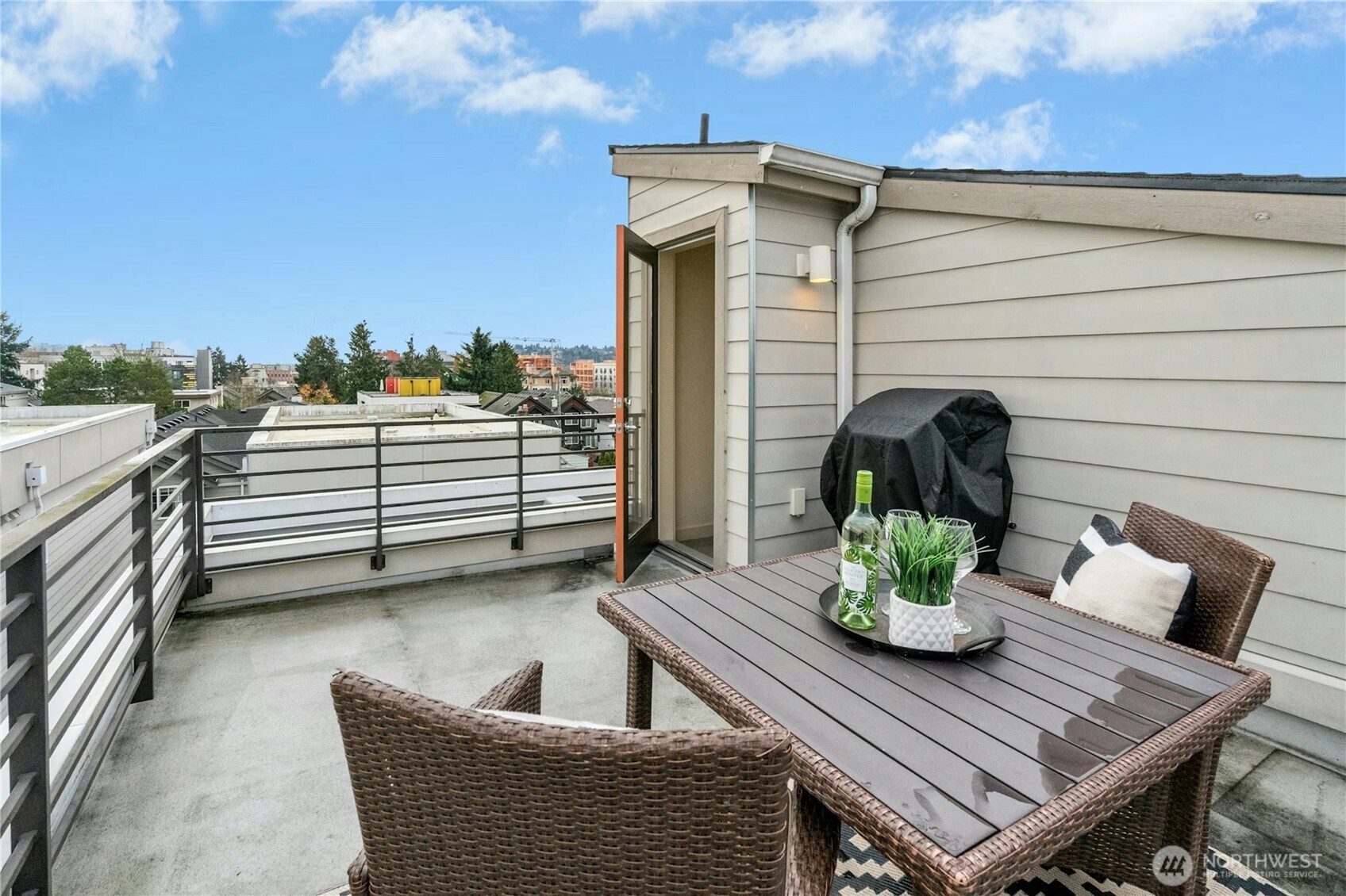 1743 Northwest 60th Street, Unit A Seattle, WA 98107 - Photo 23 of 33 a view of a deck with a table and chairs and potted plants