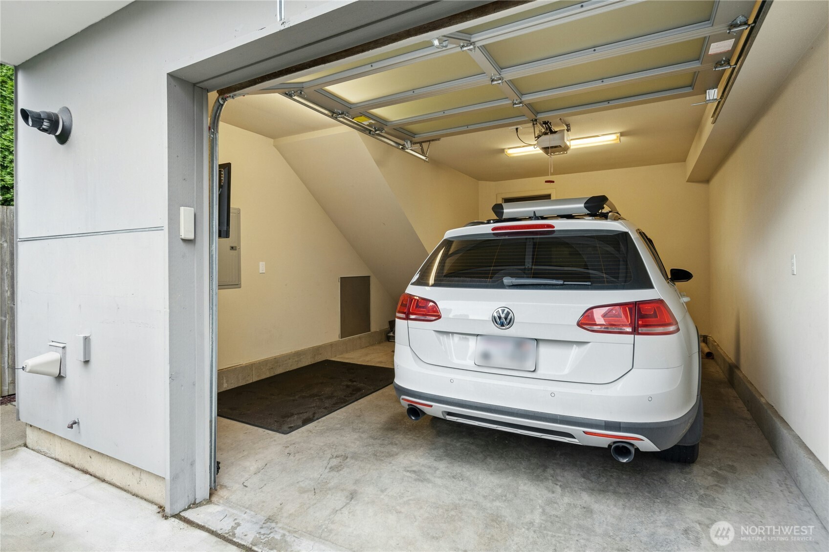 1743 Northwest 60th Street, Unit A Seattle, WA 98107 - Photo 26 of 33 a car and bike parked in a garage