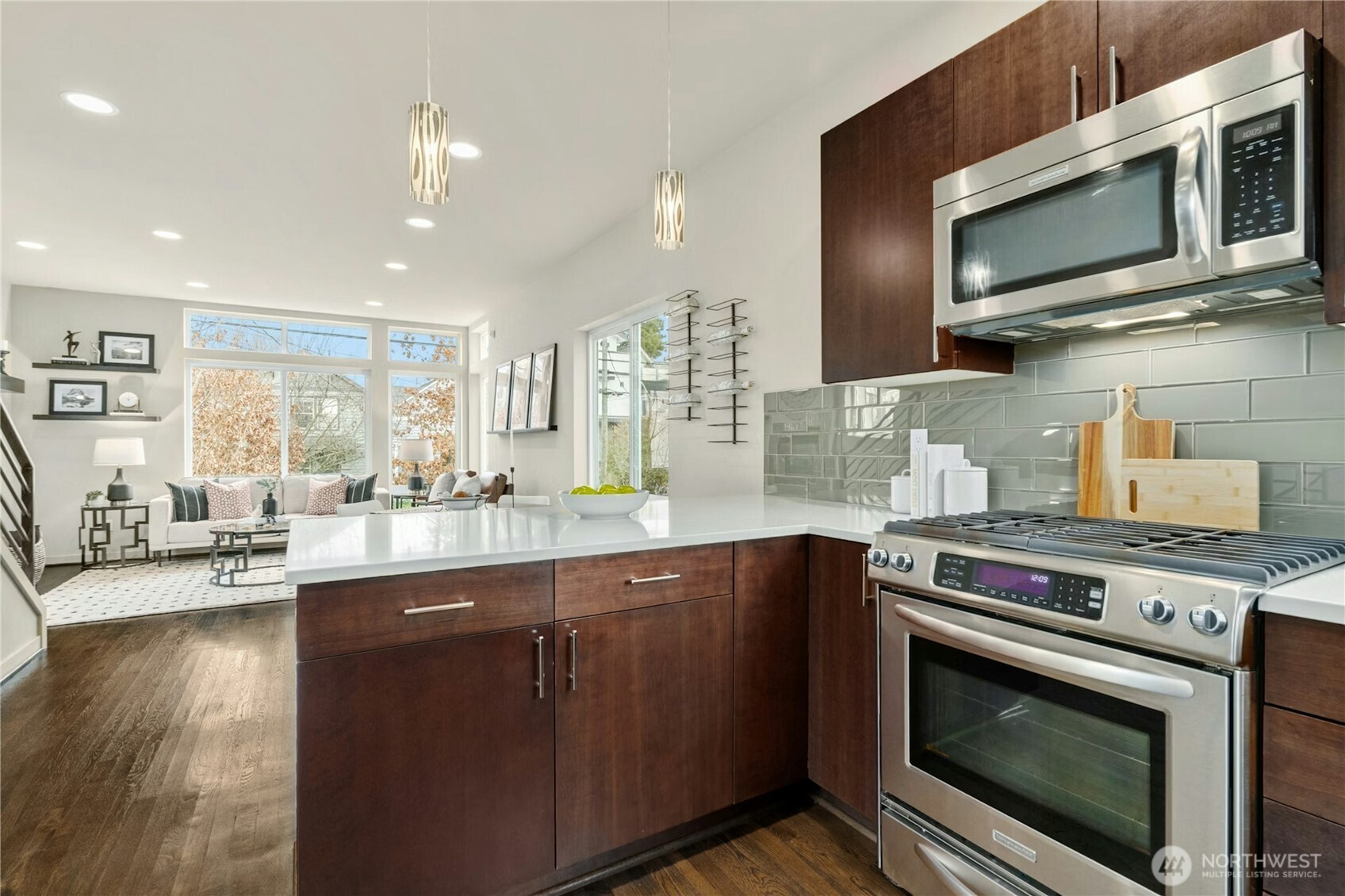 1743 Northwest 60th Street, Unit A Seattle, WA 98107 - Photo 6 of 33 a kitchen with stainless steel appliances granite countertop a stove a sink and a microwave