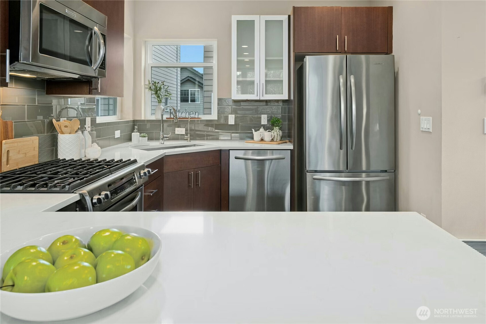 1743 Northwest 60th Street, Unit A Seattle, WA 98107 - Photo 7 of 33 a kitchen with stainless steel appliances a sink a stove a refrigerator and cabinets