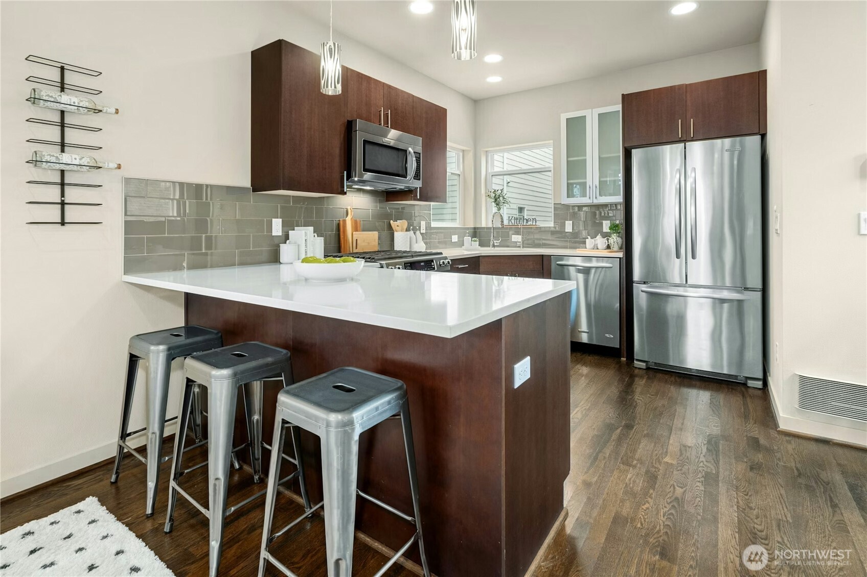 1743 Northwest 60th Street, Unit A Seattle, WA 98107 - Photo 8 of 33 a kitchen with stainless steel appliances a microwave a sink and a refrigerator