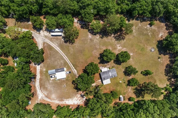 an aerial view of residential house with outdoor space and lake view