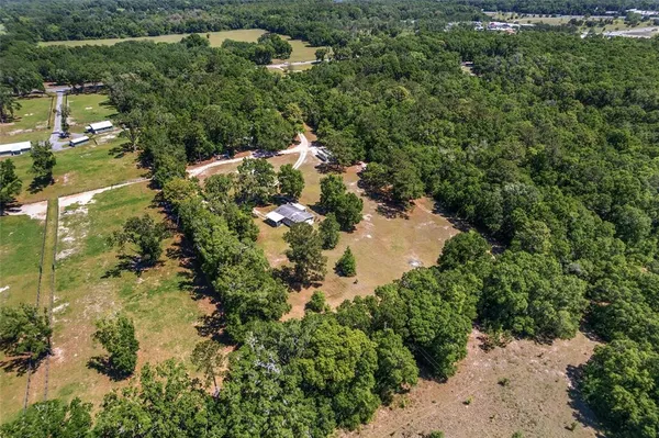 an aerial view of a houses with yard