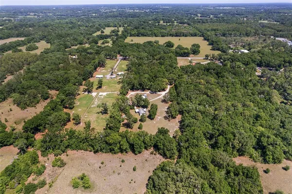 a big yard with lots of green space and house lake view