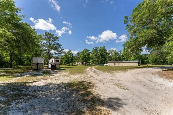 a view of a green yard with a house