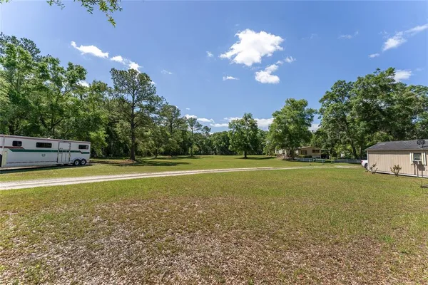 a view of a field with trees in front of it