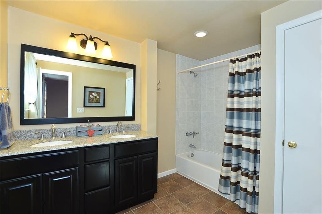 102 Deer Road Pittsburgh, PA 15237 - Photo 10 of 21 Remodeled Master Bath - Double sink vanity, ceramic tile floor, updated light fixture, large linen closet.