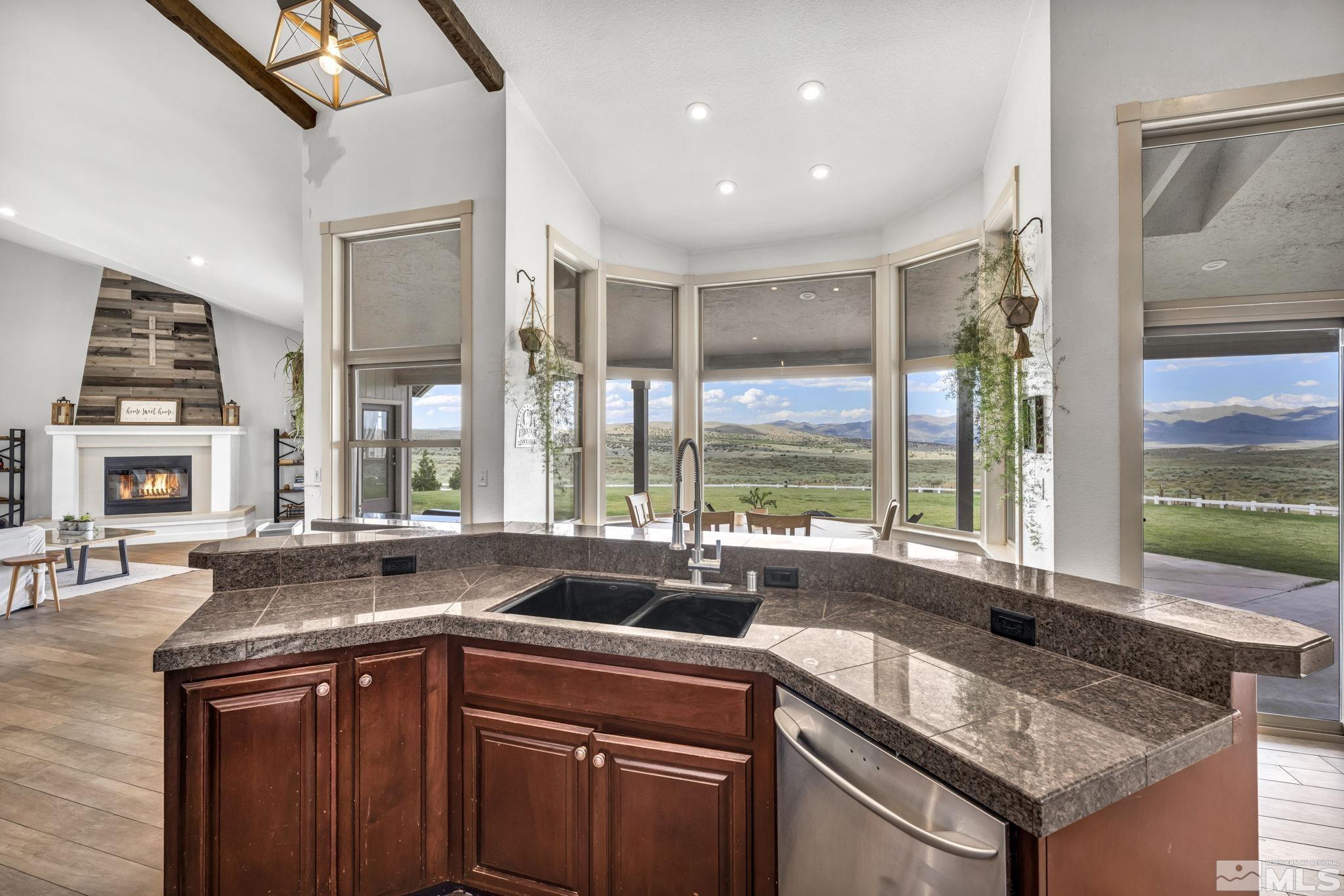 400 Desert Sun Lane Reno, NV 89508 - Photo 13 of 40 a kitchen with a sink and large windows