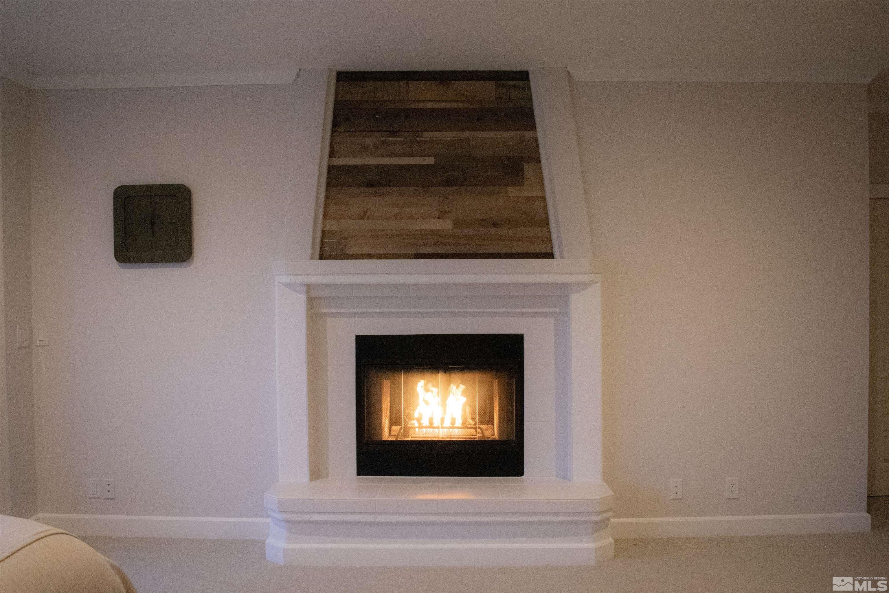 400 Desert Sun Lane Reno, NV 89508 - Photo 17 of 40 a living room with a fireplace and a flat screen tv