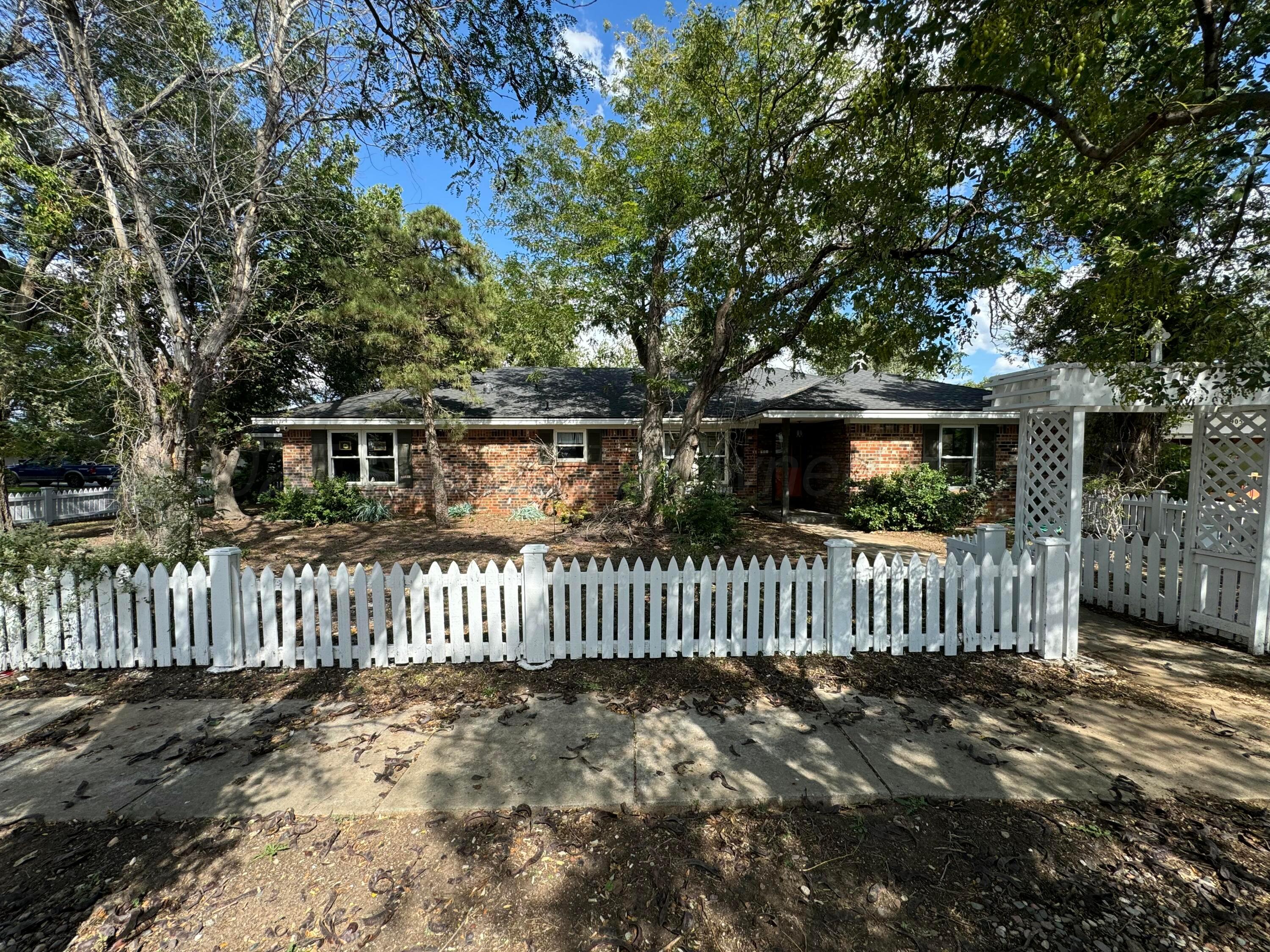 a view of a house with wooden fence