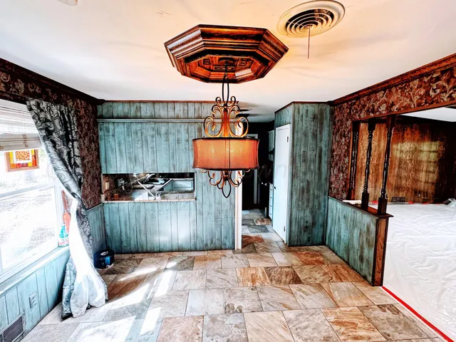 a room that has a bed and a chandelier