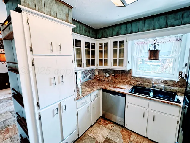 a kitchen with stainless steel appliances granite countertop a sink and cabinets