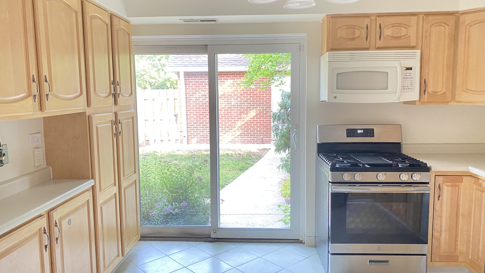 23 North Tower Road Oak Brook, IL 60523 - Photo 14 of 22 a kitchen with white cabinets and a stove
