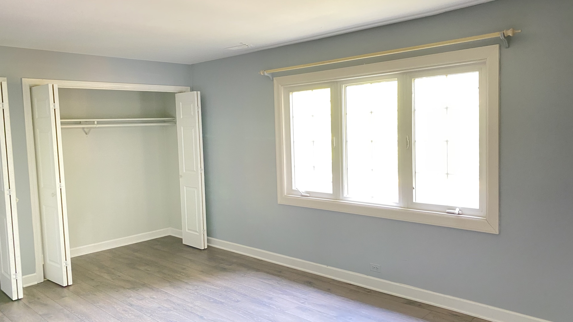 23 North Tower Road Oak Brook, IL 60523 - Photo 20 of 22 a view of an empty room with wooden floor and a window