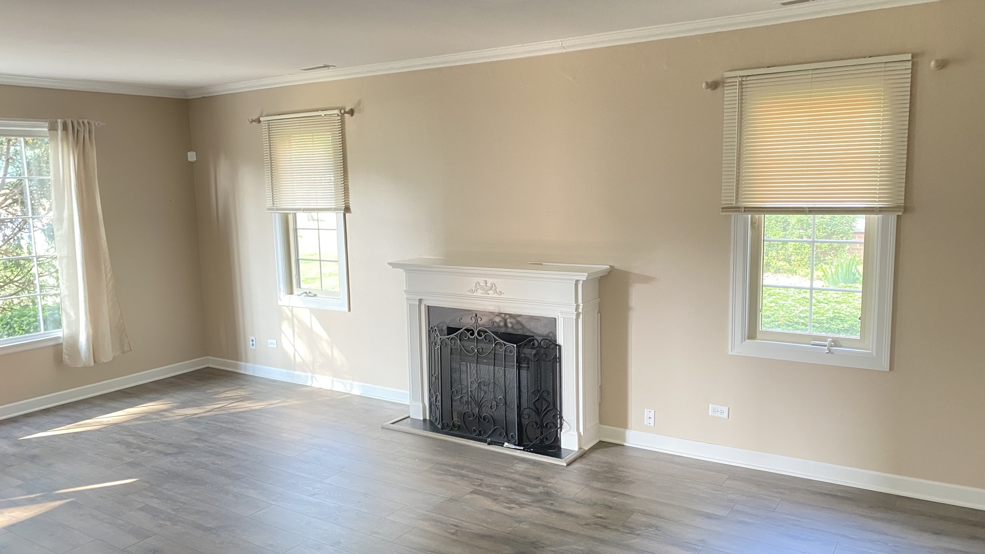 23 North Tower Road Oak Brook, IL 60523 - Photo 10 of 22 an empty room with wooden floor fireplace and windows