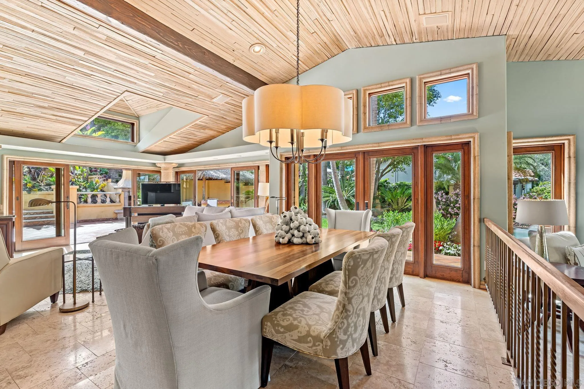 2969 Racetrack View Drive Del Mar, CA 92014 - Photo 9 of 59 a dining room with furniture large windows and a chandelier