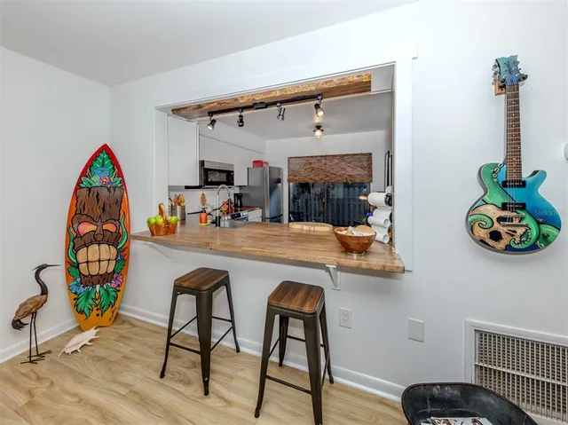 a kitchen with stainless steel appliances granite countertop a refrigerator and a stove top oven