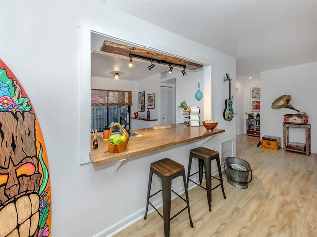 a kitchen with granite countertop a sink and a stove top oven