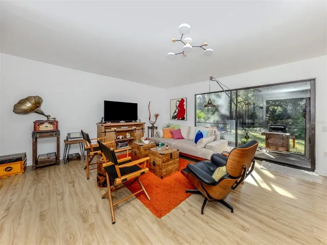 a view of a dining room with furniture and a chandelier