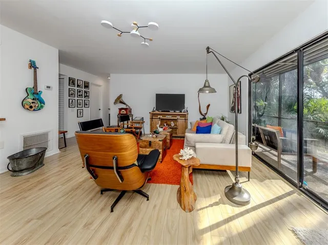 a dining room with furniture and a flat screen tv