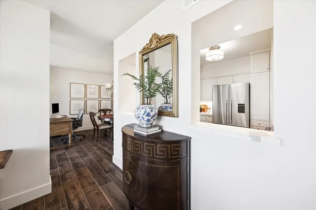 a view of a dining room with furniture a chandelier and wooden floor