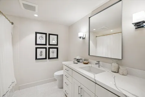 a living room with furniture flat screen tv and a large window