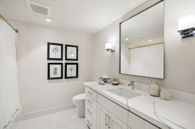 a living room with furniture flat screen tv and a large window