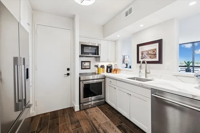 a kitchen with a sink and a refrigerator