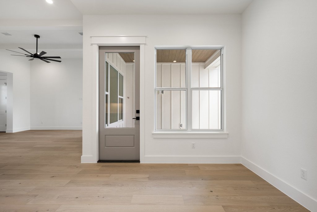 501 Ranchview Drive Johnson City, TX 78636 - Photo 23 of 28 an empty room with a window and a ceiling fan
