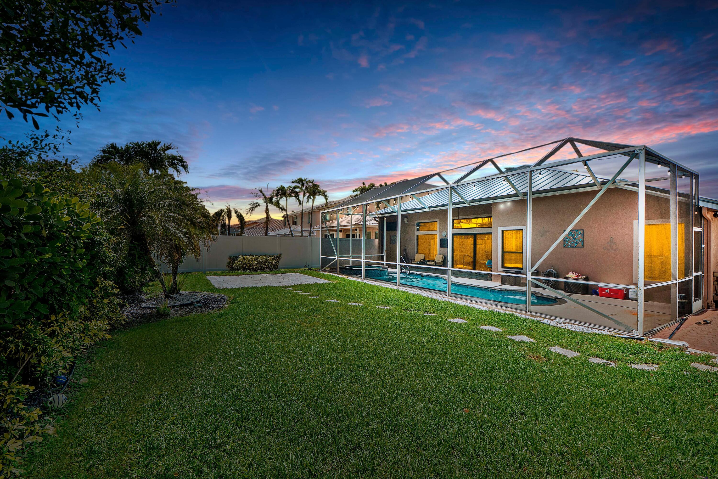 12328 St Simon Drive Boca Raton, FL 33428 - Photo 3 of 52 a view of a house with a backyard porch and sitting area