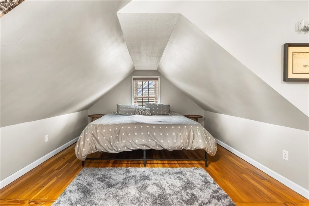 321 Winter Street Barnstable, MA 02601 - Photo 19 of 35 a bedroom with a bed and wooden floor