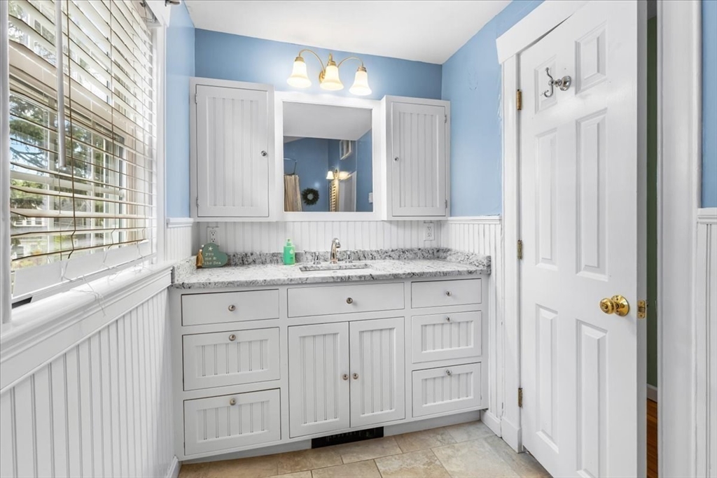 321 Winter Street Barnstable, MA 02601 - Photo 20 of 35 a bathroom with a granite countertop sink and a mirror