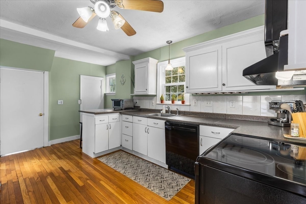 321 Winter Street Barnstable, MA 02601 - Photo 6 of 35 a kitchen with a sink stove and cabinets