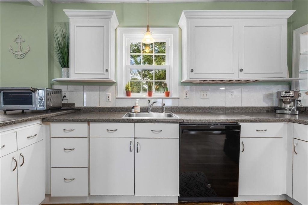 321 Winter Street Barnstable, MA 02601 - Photo 9 of 35 a kitchen with granite countertop white cabinets and a stove