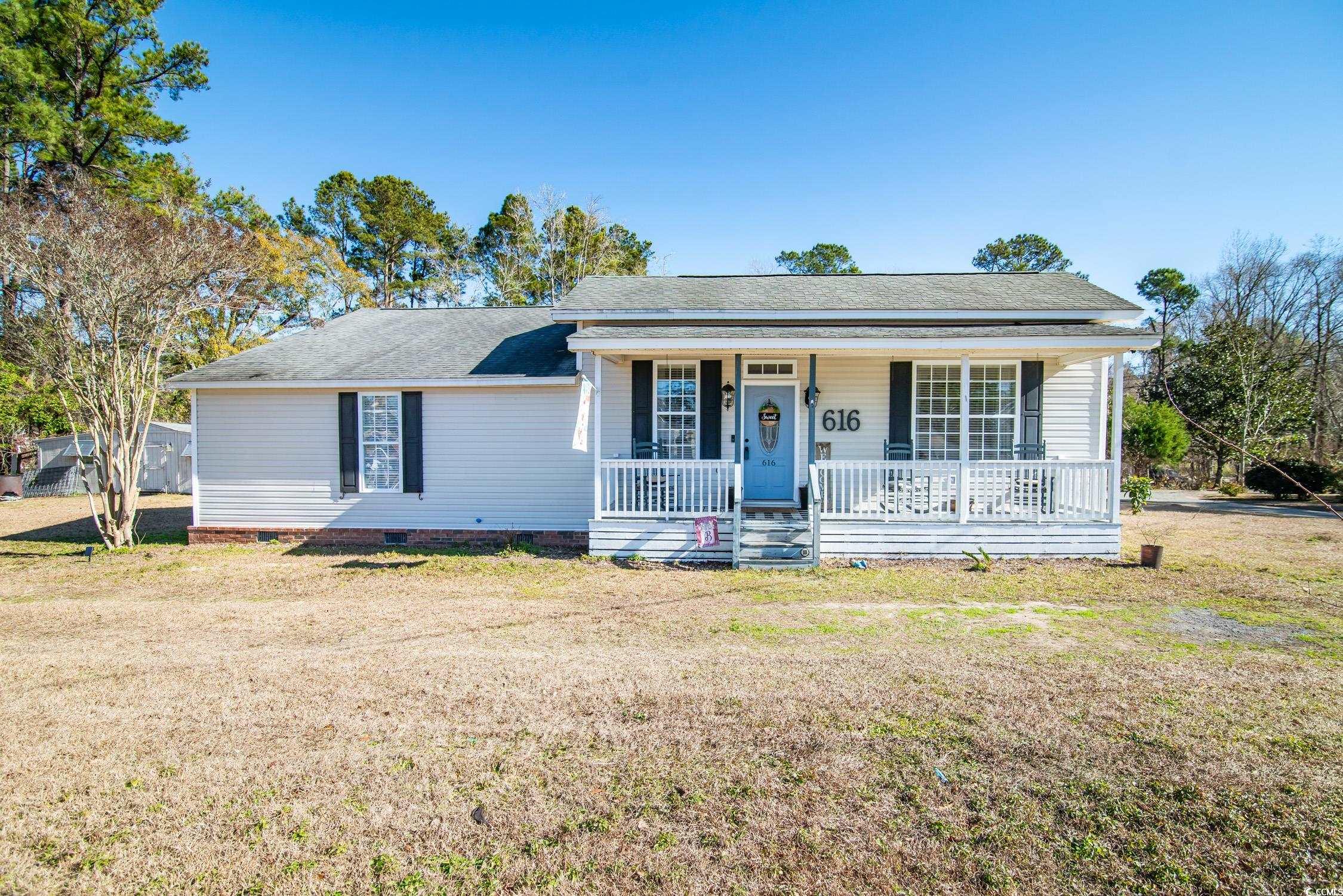616 County Rd S-22-452 Georgetown, SC 29440 - Photo 1 of 33 Single story home featuring a porch and a front la
