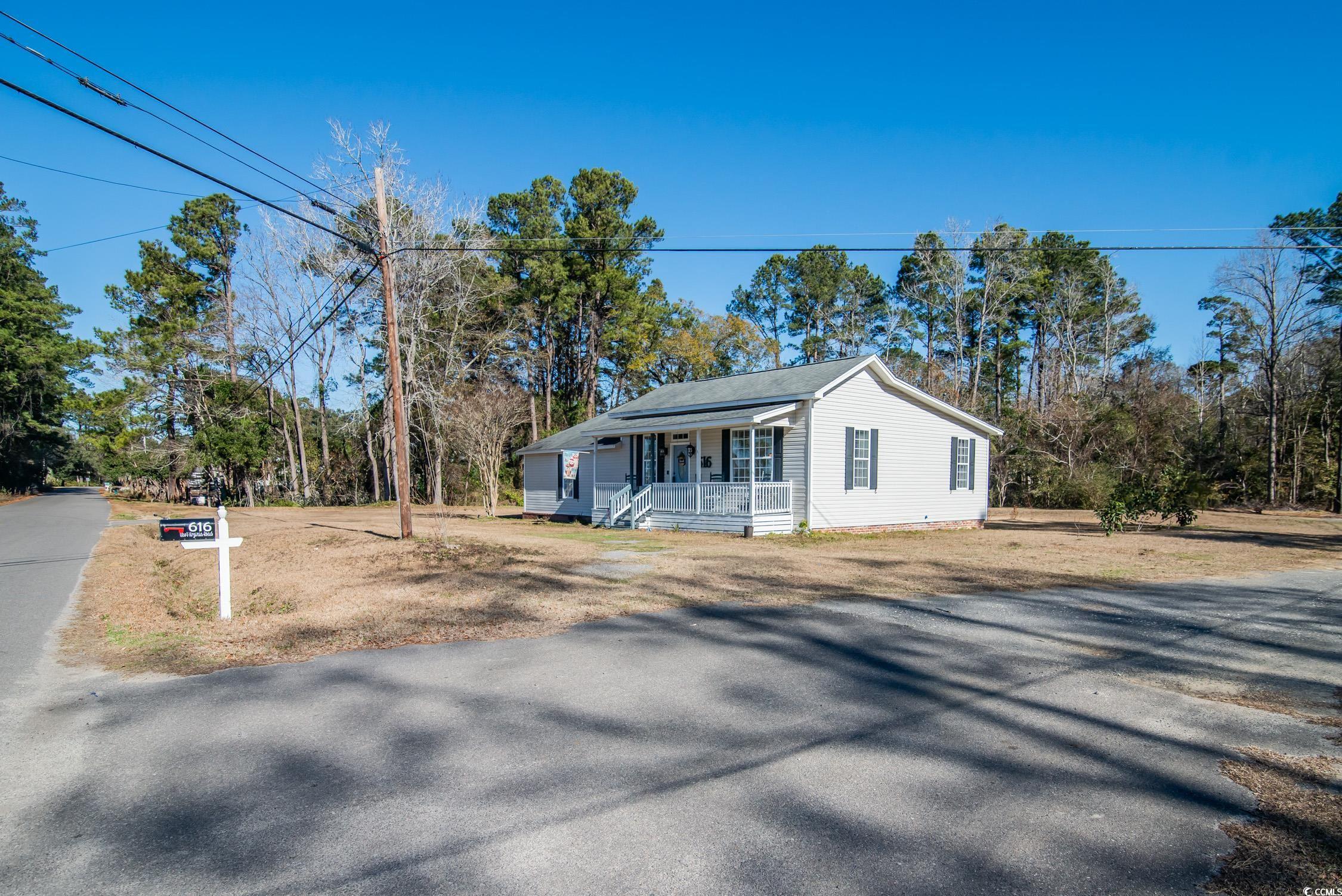 616 County Rd S-22-452 Georgetown, SC 29440 - Photo 3 of 33 View of front facade featuring covered porch