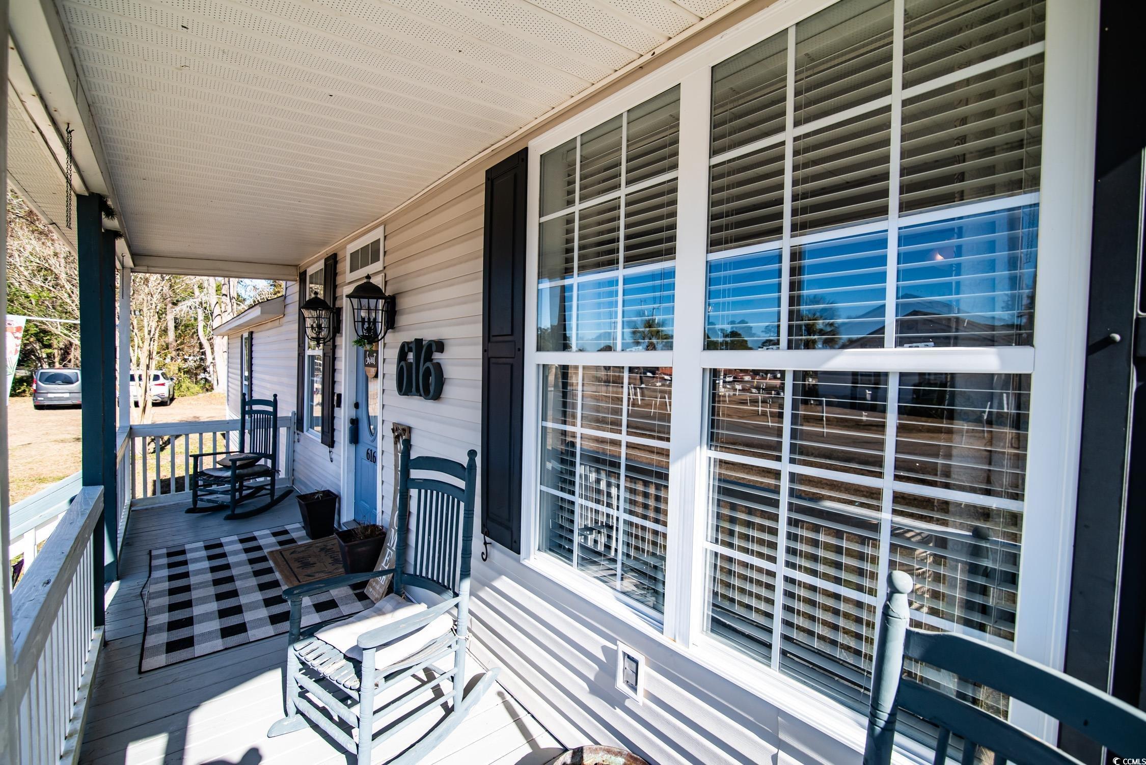 616 County Rd S-22-452 Georgetown, SC 29440 - Photo 4 of 33 Wooden deck featuring covered porch