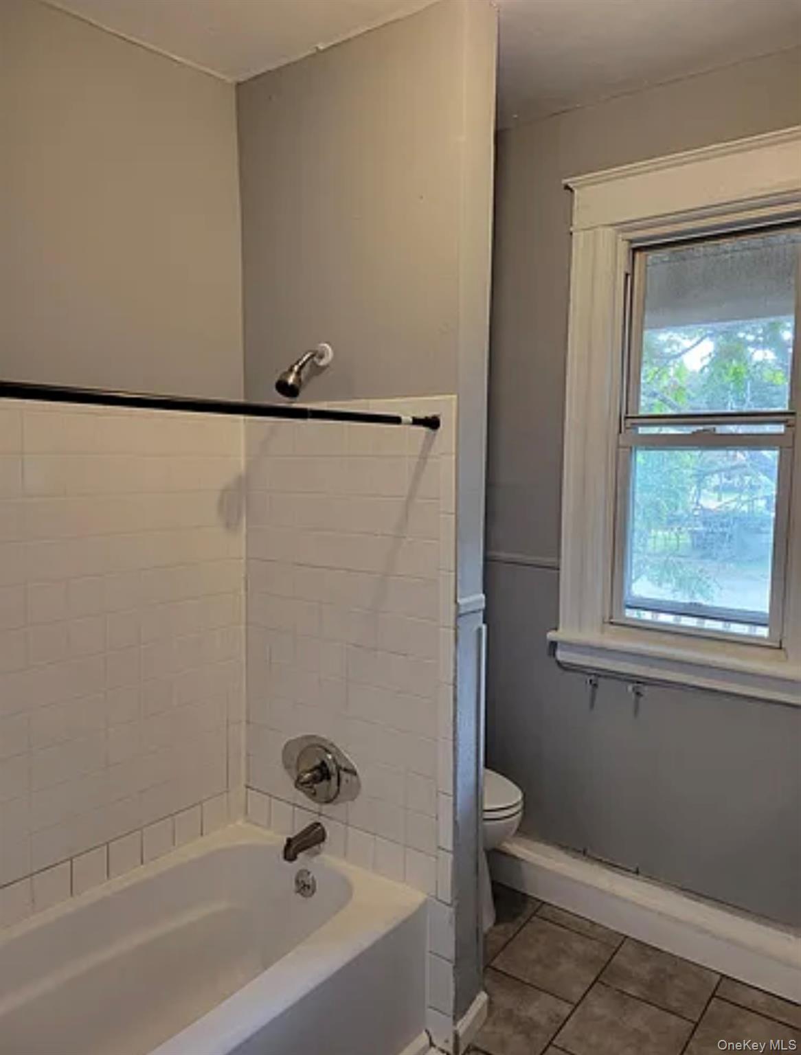 91 Pershing Avenue Poughkeepsie, NY 12601 - Photo 11 of 13 a bathroom with a bathtub and a shower